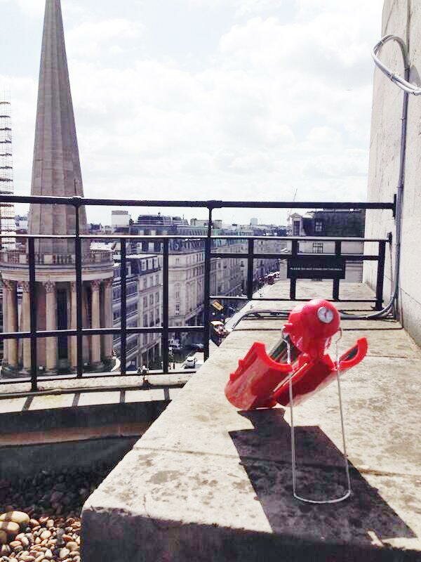 Red solar kettle on rooftop balcony at BBC